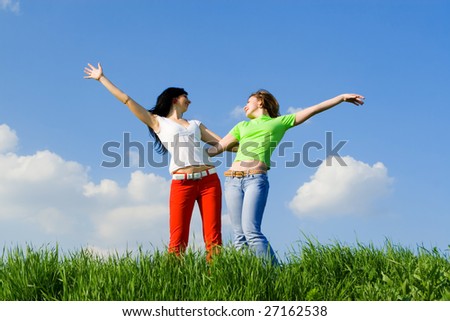 two happy young women dreams to fly on winds