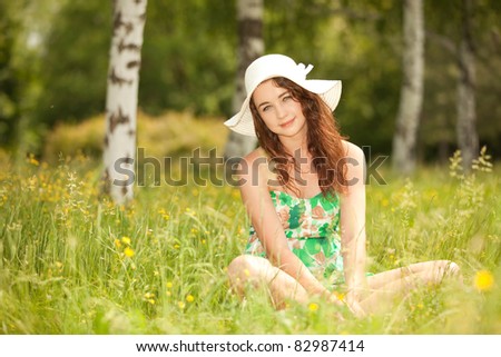 Young redhead woman in the park