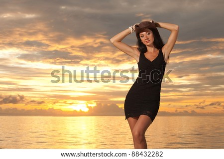 Fashion woman on the sea sunset background