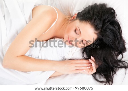 Cute woman sleeping on the white bed