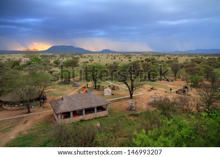 A safari camp in the serengeti as a storm moves in