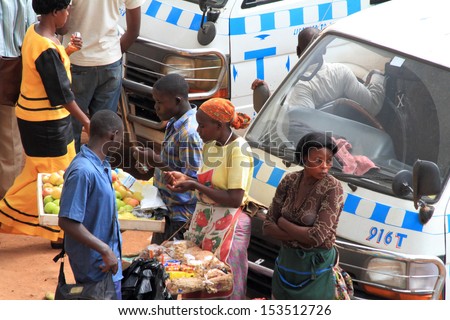 KAMPALA, UGANDA - SEPTEMBER 28, 2012.  People sell and buy merchandise in the taxi park in Kampala, Uganda on September 28,2012.