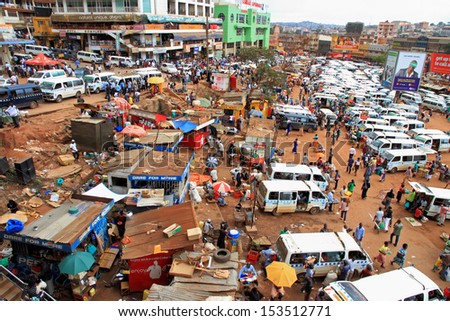 KAMPALA, UGANDA - SEPTEMBER 28, 2012.  People and taxis move about their busy day in the downtown taxi park in Kampala, Uganda on September 28,2012.