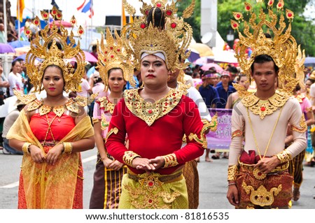 KORAT, THAILAND - JULY16: Traditional candle procession festival.People in Thai costume to march along with many others, happily in festival. July 16, 2011 in Korat, Thailand.