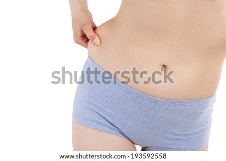 Weight loss, diet and body fat. Sexy woman in underwear making showing body fat and her hips isolated over white background.