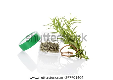 Fresh rosemary herbs and dry rosemary spice in glass jar isolated on white background. Culinary healthy aromatic herbs. Culinary arts.