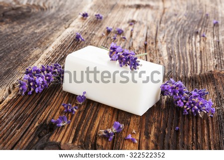 Lavender background. Fresh lavender blossom and lavender soap on brown aged wooden background, rustic country style.