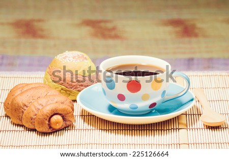 Coffee and bread on floor, vintage stylized photo
