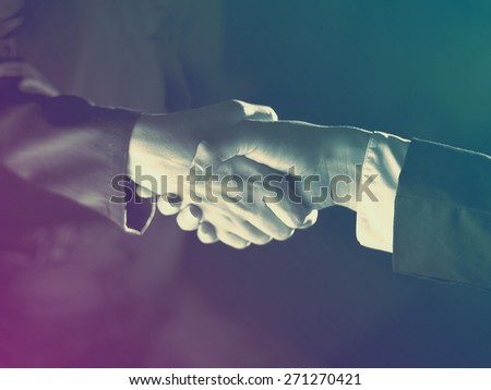 Handshake Handshaking dark and light, sepia tone