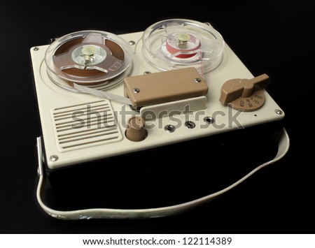 a small vintage reel to reel tape recorder