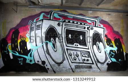 a graffiti artwork of a boom box ghettoblaster on a wall 
