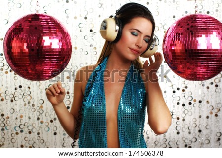 beautiful dancing woman in blue costume with headphones