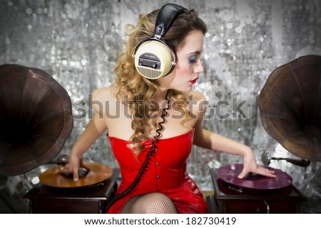 beautiful sexy disco dj in red dress with gramophones. Perfect for stylish club, disco and fashion events