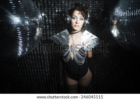 sexy disco party woman dressed in a unique silver costume with metal wings. Perfect for stylish club, disco and fashion events