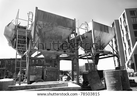 industrial concrete cement mixer bins at construction work site.