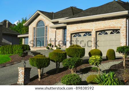 luxury  bungalow house and garage with ornamental  landscaping garden and paved driveway