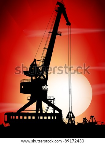 Silhouettes of port crane on a sunset