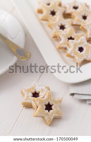 Star shaped sugar cookies on white serving plate