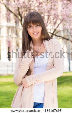 Pleasant young woman posing in pink cardigan sweater