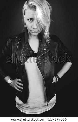 Beautiful portrait of rock woman model in leather jacket with dark evening make-up. Perfect street fashion.