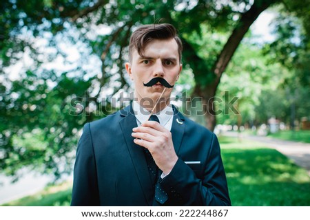 funny groom with false mustache