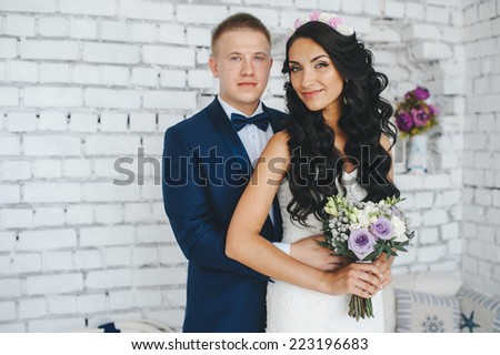wedding couple in the interior of a white decorated studio decorated