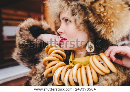Winter Girl in Luxury Fur Coat and hat with bagels. Fashion Fur