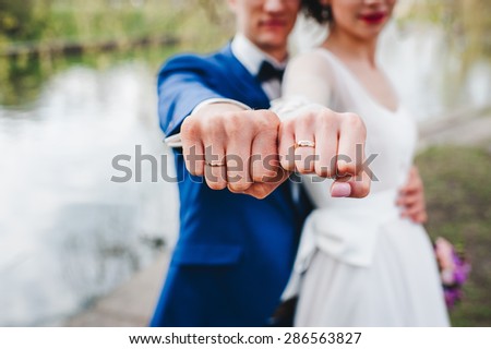 Bride and groom show the rings