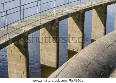 Reservoir details water and brickwork, with metal railings. Taken at Ogden water reservoir in West Yorkshire.
