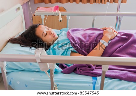 Asian female patient lay down on bed in hospital