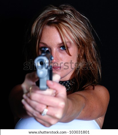 Young Woman Pointing a Gun with Main Focus on Woman