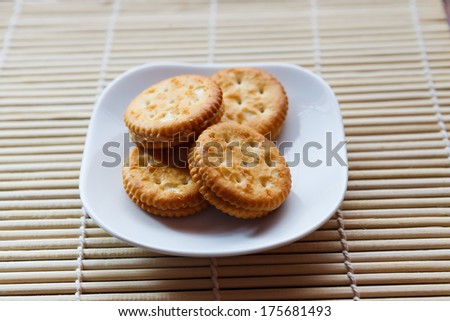 Cookies on the dish with wooden ground.