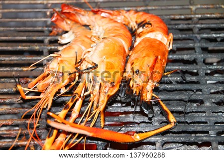 Barbecue of grilled shrimps on gridiron charcoal stove