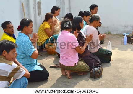 MAHASARAKHAM, THAILAND - APRIL 22 : Unidentified cousins keep dead person bone ash in holy place and make religious merit at Nong Wang village temple on April 22, 2013 in Mahasarakham, Thailand.