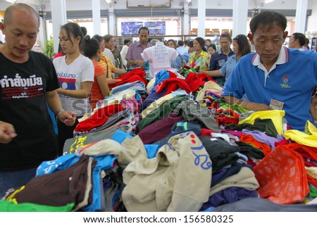 VIENTAINE, LAO P.D.R. - AUGUST 25 : Unidentified tourists are buying clothes at duty free shop on August 25, 2013 in Vientaine, Lao P.D.R.