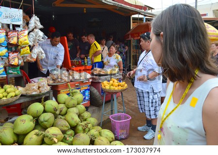 KA LAN, CAMBODIA - NOVEMBER 24 : Tourists are buying food and drink at local market on November 24, 2013 in Ka Lan, Cambodia.