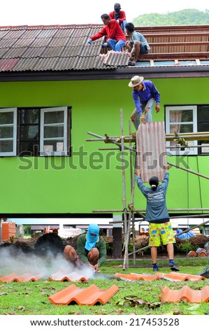 KHAO YAI, KORAT - JUNE 21 : Workers are repairing house roof of Klong Sai Resort on June 21, 2014 in Khao Yai, Korat, Thailand.