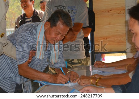 MAHASARAKHAM - JANUARY 29 : Old woman goes to vote for village headman election at Ban Nong Hin on January 29, 2015 in Muang, Mahasarakham, Thailand.