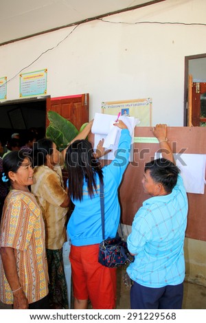 PAYAKKAPHUMPHISAI  - JUNE  28 : Villagers check name list to vote for representative of farmer\'s reconstruction and development fund on June 28, 2015 in Payakkaphumphisai, Mahasarakham, Thailand.