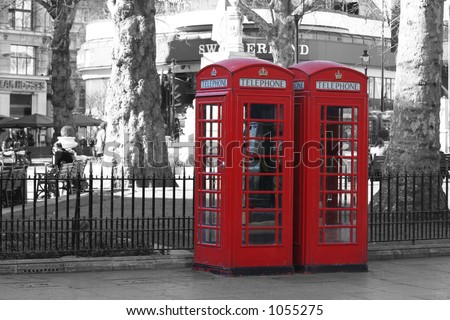 Red London telephone boxes at Leicester Square (on a B&W background)