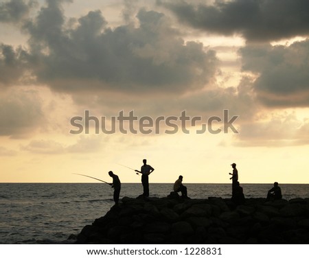 People fishing at sunset