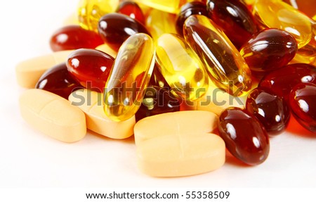 red and yellow pills on white background (shallow DOF)