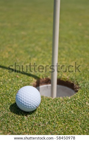 golf hole with ball and flag