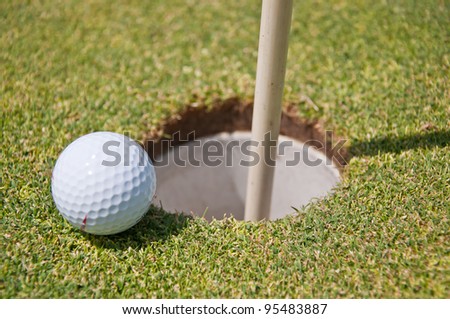 golf hole with ball and flag