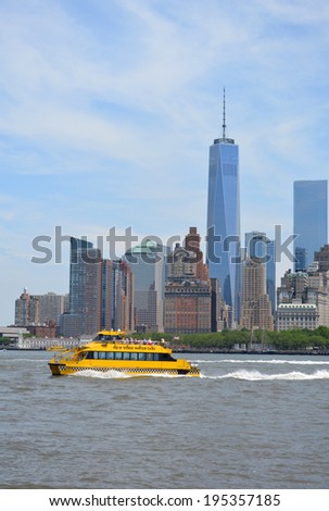 NEW YORK CITY, USA - May 26, 2014: Water taxi cruising through New York Harbor with the Lower Manhattan skyline in the background.