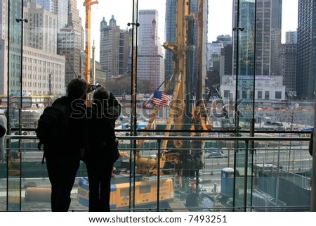 A couple taking photos of the construction at Ground Zero, New York City.