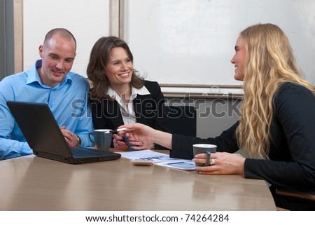 Caucasian professional businesswoman giving advice to caucasian couple in a conference room