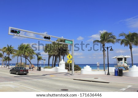 FORT LAUDERDALE, FLORIDA - MARCH 3, 2013: View from across the street of the opening to Sebastian beach at the end of Sebastian Street where it intersects with State Road A1A on a sunny day in winter