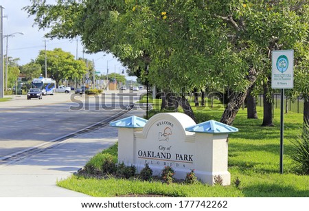 OAKLAND PARK, FLORIDA - MAY 11, 2013: Tree City USA sign next to a sign on the side of North Dixie Highway south of Oakland Park Boulevard welcoming people to the City of Oakland Park, Florida.