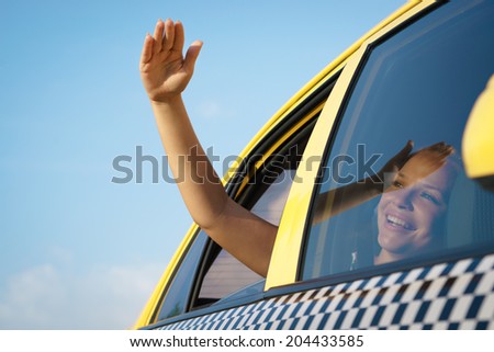 people travelling. Female passenger in taxi with arm outside of car window waving hand. Concept of freedom